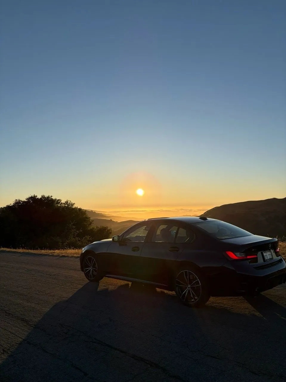Car overlooking the hills at sunset in Carmel, California