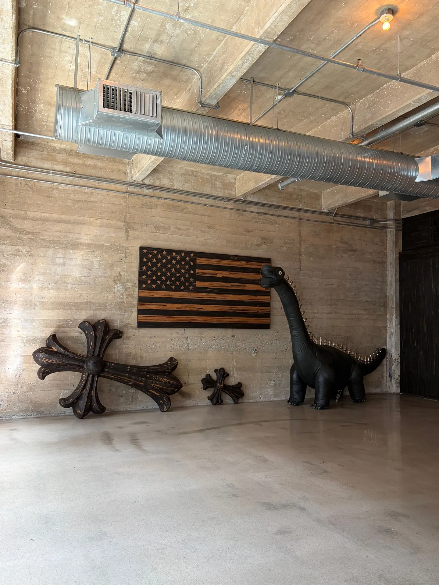 Dinosaur sculpture and wooden pieces at Chrome Hearts New York