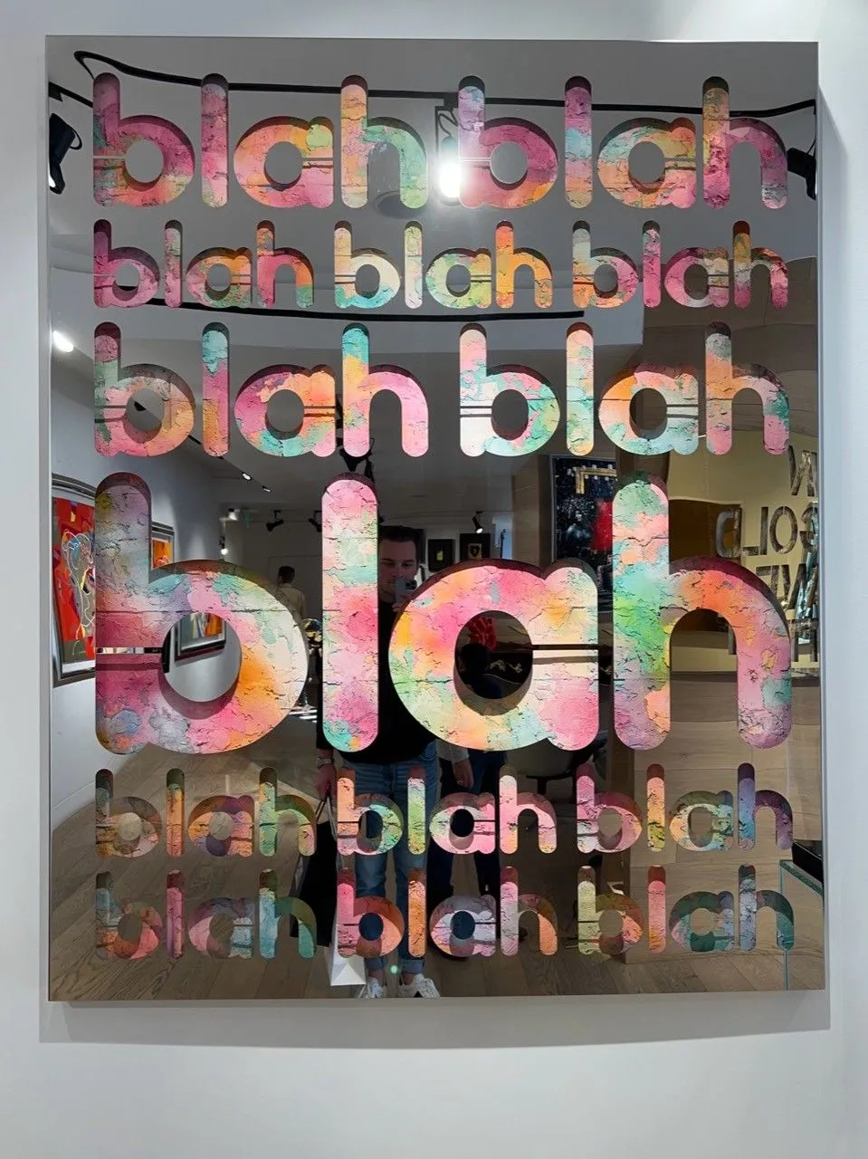 Colorful repeated blah lettering on a mirrored artwork